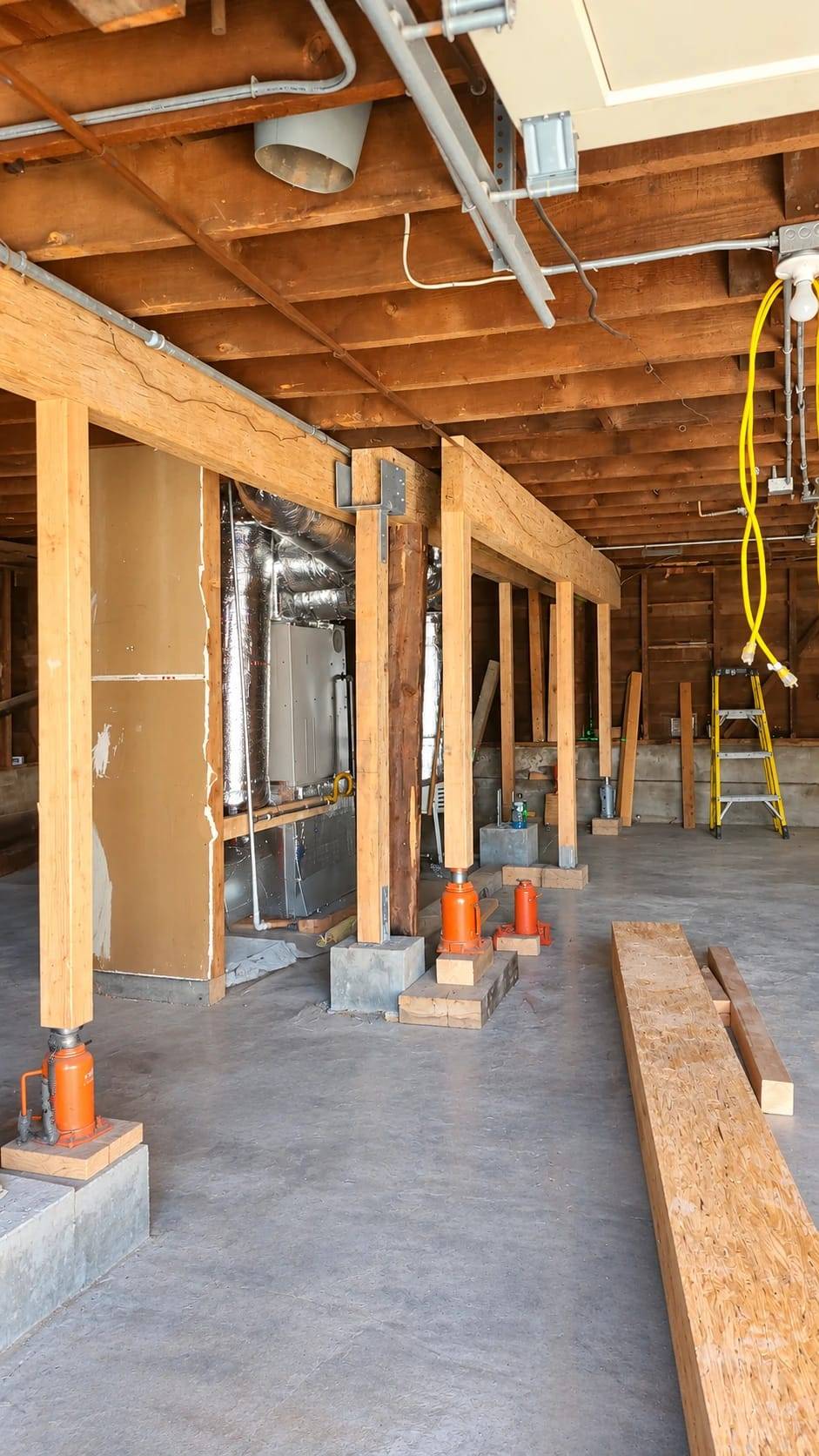 Temporary shoring posts on hydraulic jacks carrying a Bay Area home while Gadget Construction replaces a failed beam